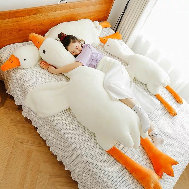 Cute big white geese pillow plush toy resting on a child’s bed, offering cozy comfort and adorable room decor