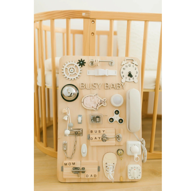 Interactive busy board baby toy featuring zippers, switches, and textures that support early childhood learning and development.